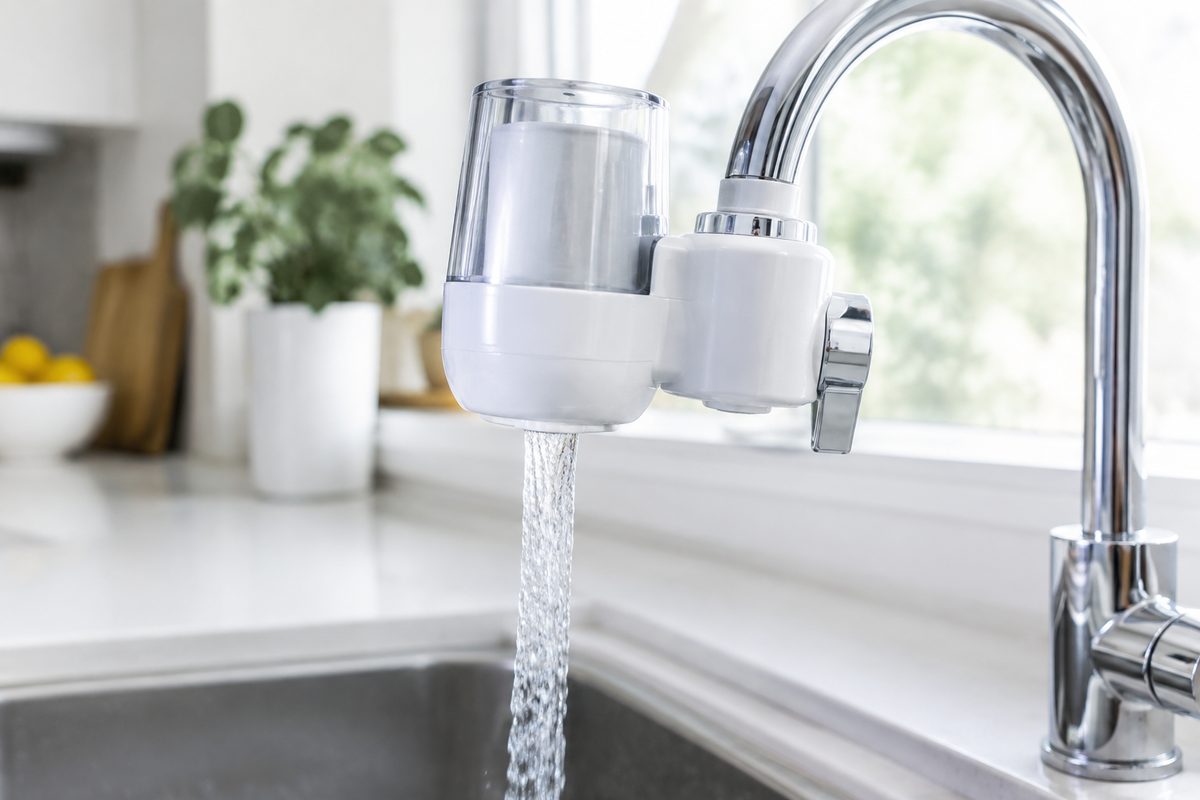 faucet-mounted water filter on chrome kitchen tap